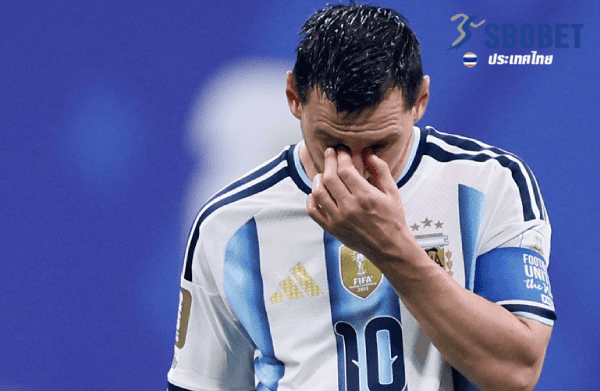 Argentina national team footballer wearing number 10, touching his eye in a moment of disappointment on the pitch.